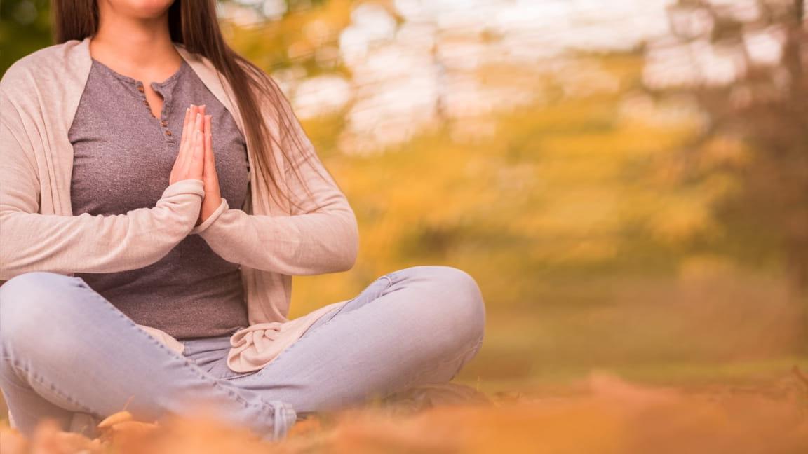 woman meditating with praying hands