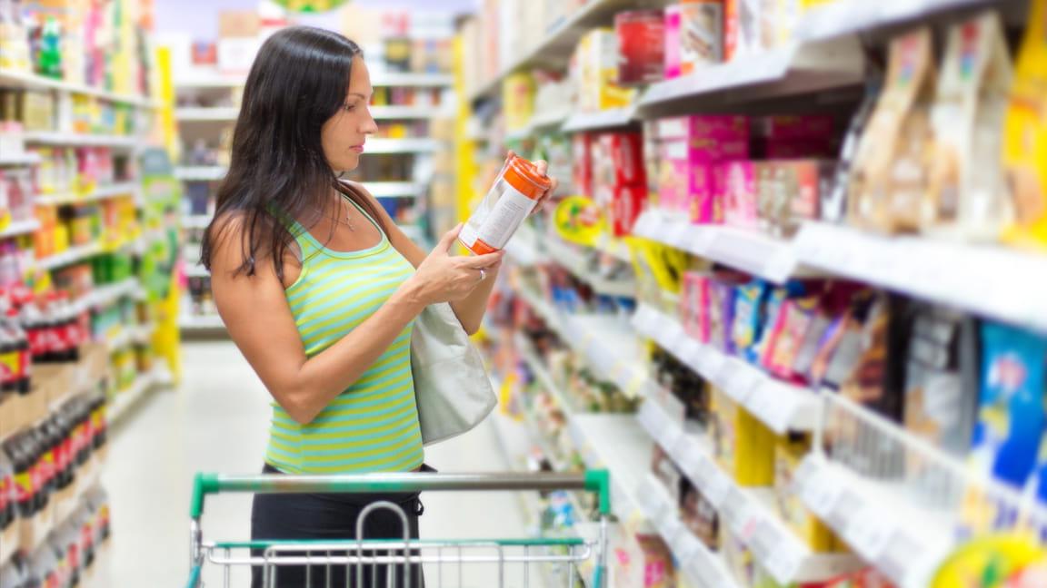 woman reading label in store