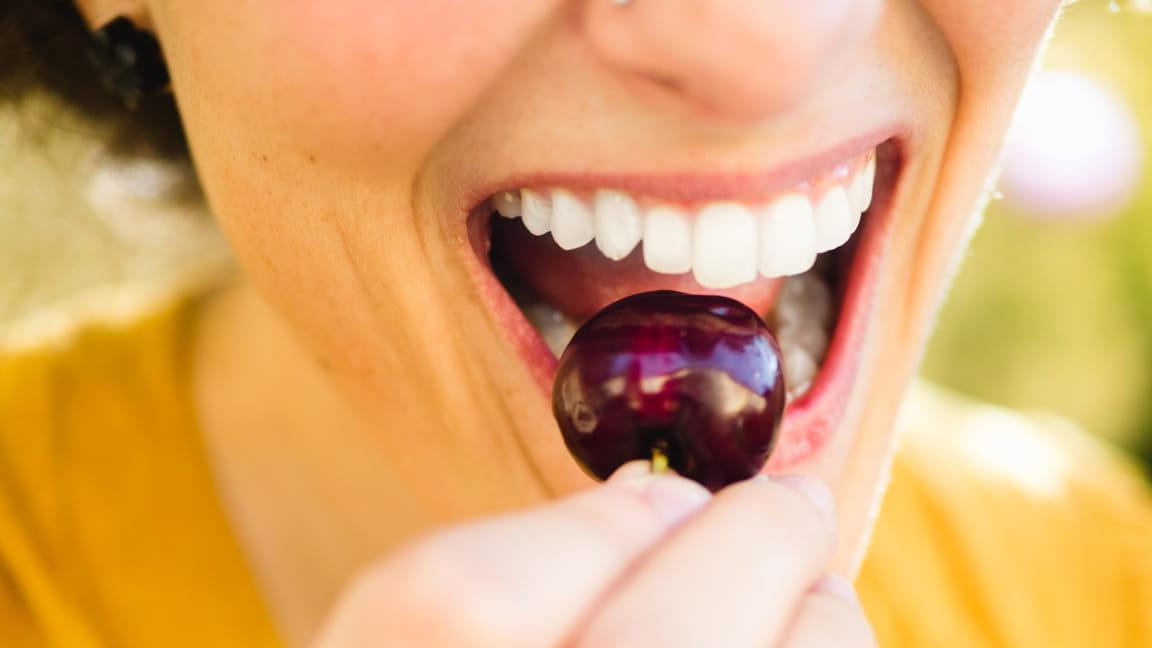 woman eating cherry