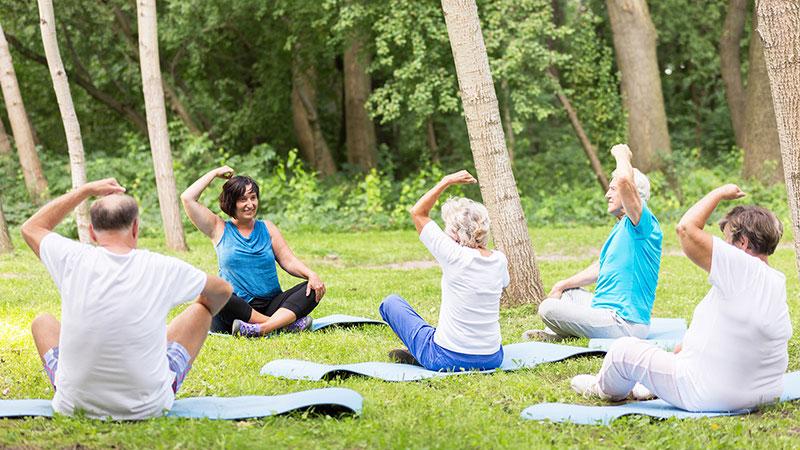 active grandparents excercising in garden